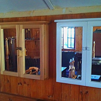 A variety of wall-mounted, solid wood mirrored cabinets