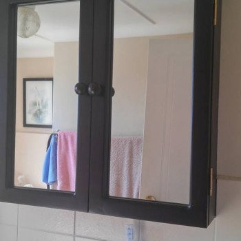 Painted bathroom storage unit with mirror