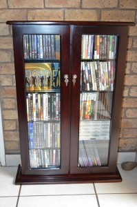Stained Saligna DVD rack, glass doors