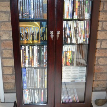 Stained Saligna DVD rack, glass doors